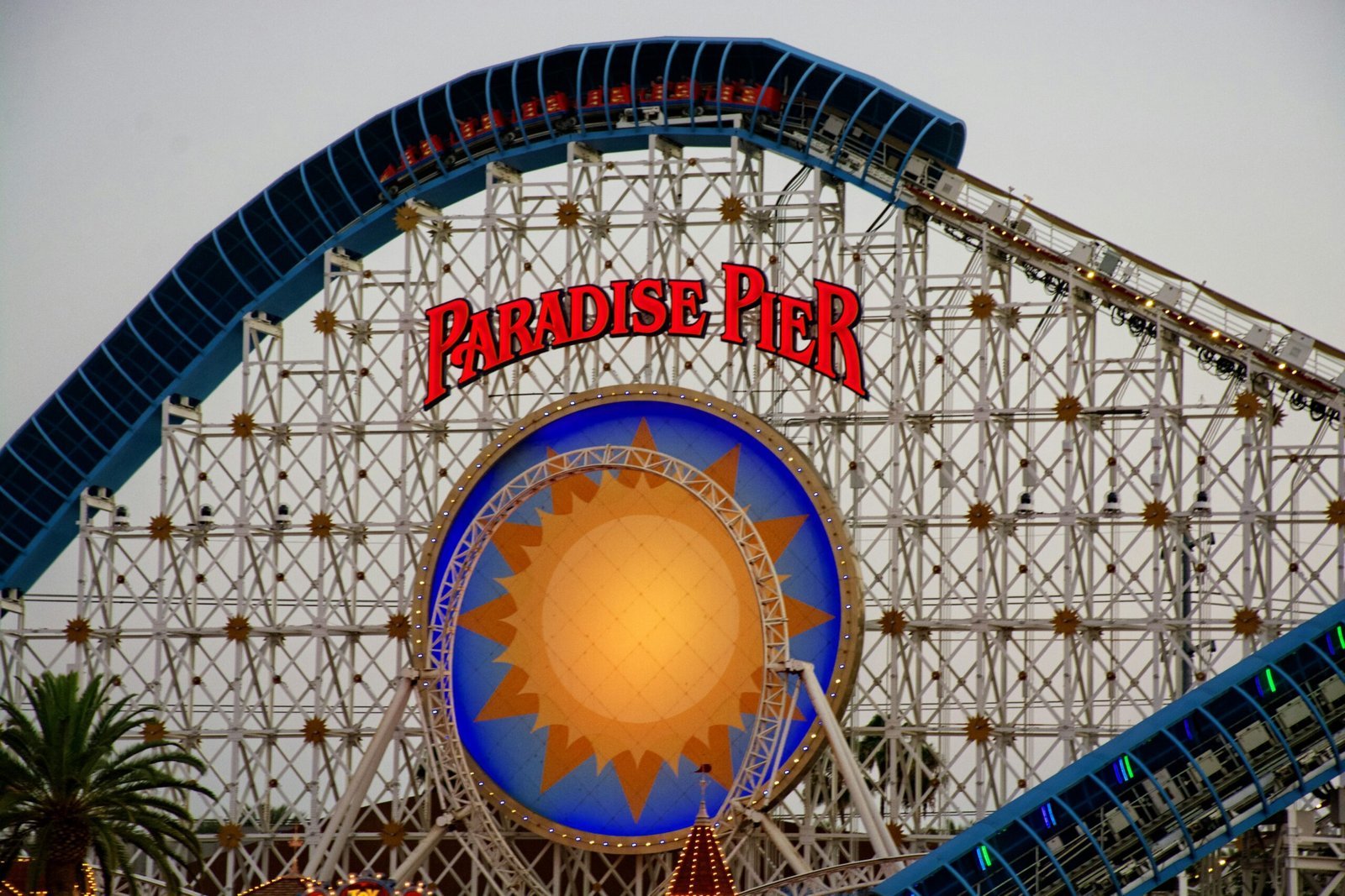 A roller coaster with a sign that says paradise pier