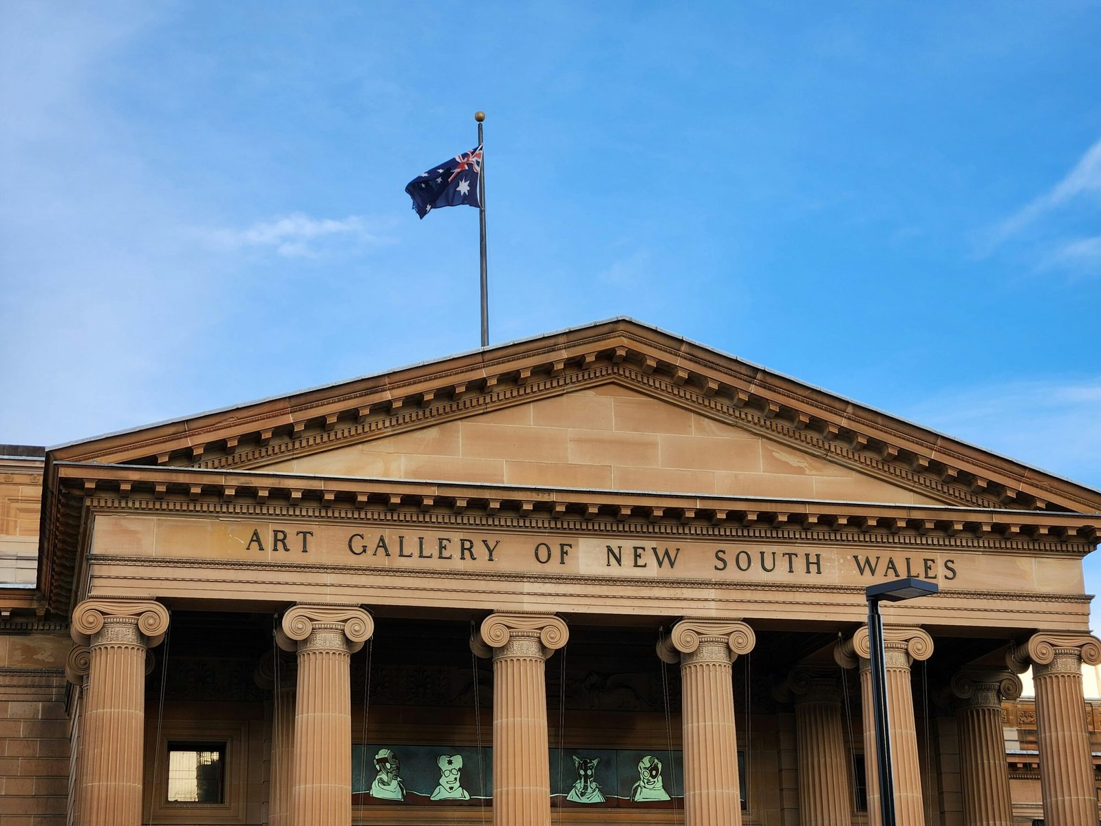 a building with pillars and a flag on top of it