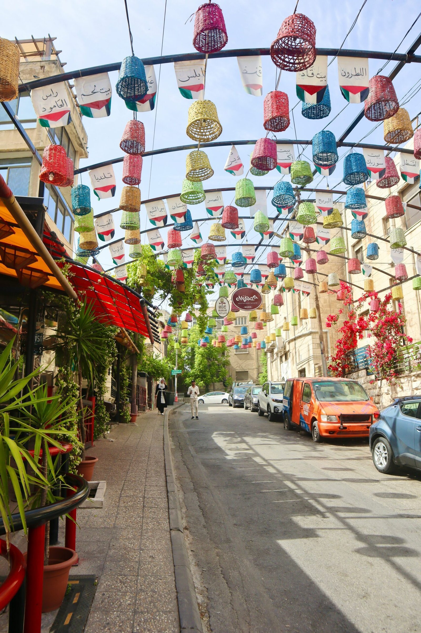 a city street lined with lots of colorful paper lanterns