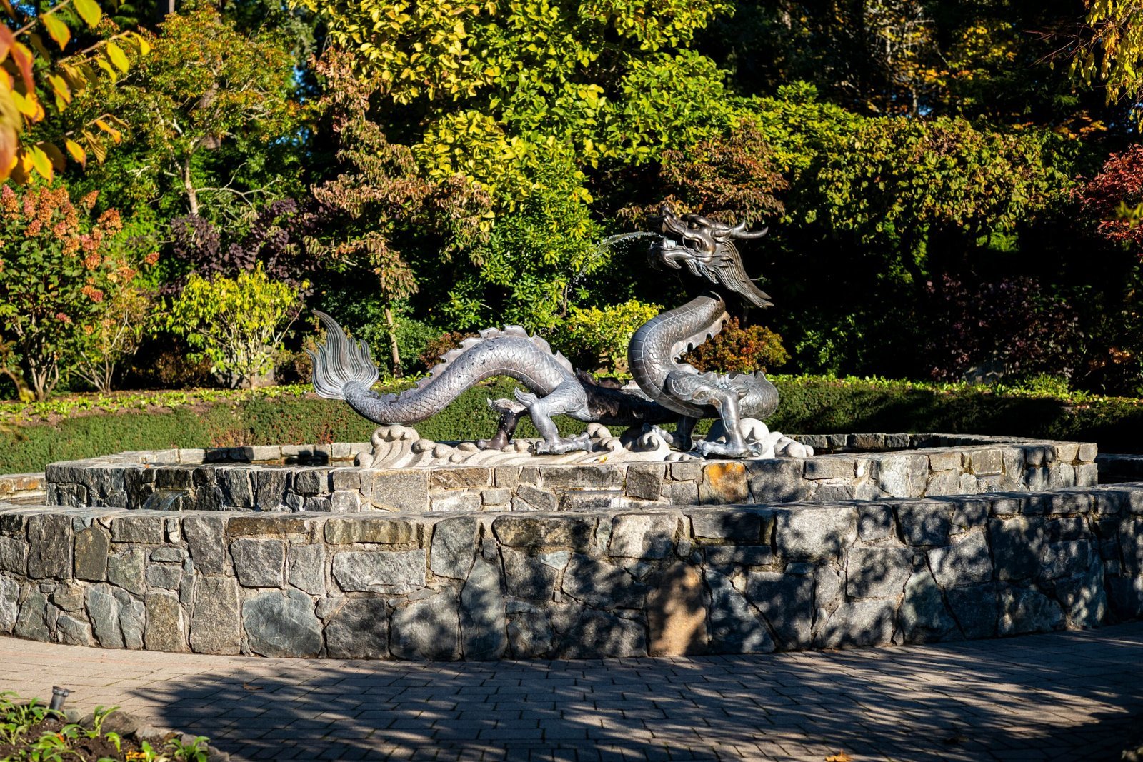 a statue of a dragon on a stone wall